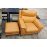 A CARAMEL LEATHER EASY CHAIR AND FOOTSTOOL ON POLISHED CHROME LEGS