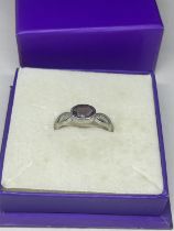 A SILVER AND AMETHYST RING IN A PRESENTATION BOX