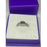 A SILVER AND AMETHYST RING IN A PRESENTATION BOX