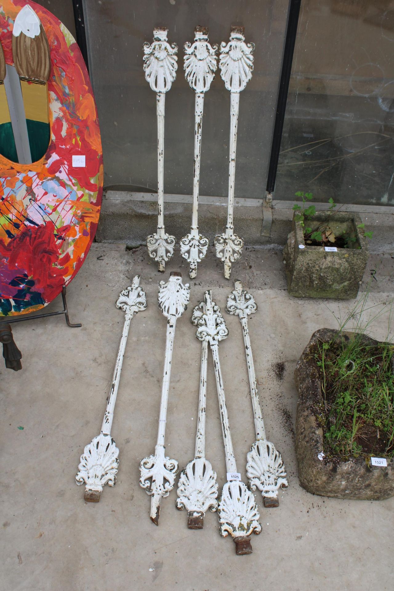 A SET OF EIGHT VINTAGE CAST IRON STAIRCASE SPINDLES