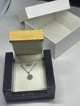 A SILVER NECKLACE IN A PRESENTATION BOX