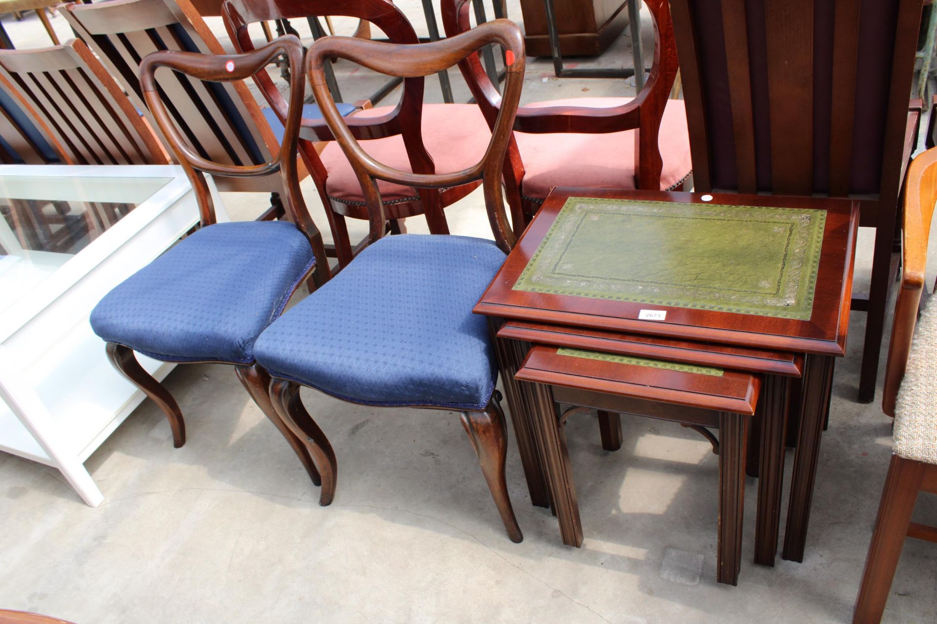 A NEST OF THREE MAHOGANY TABLES WITH INSET LEATHER TOPS AND A PAIR OF VICTORIAN PARLOUR CHAIRS