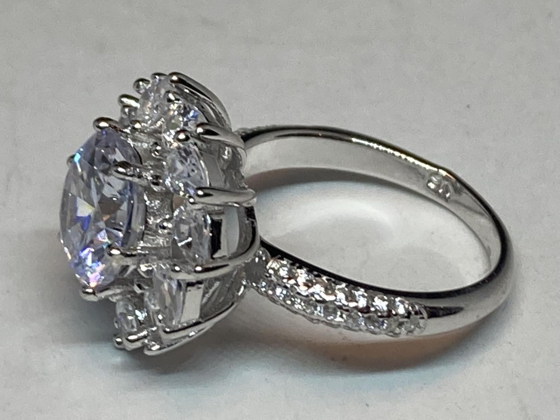 A WHITE METAL RING WITH 3 CARATS OF MOISSANITE STONES IN A FLOWER DESIGN AND ON THE SHOULDERS SIZE N - Image 4 of 8