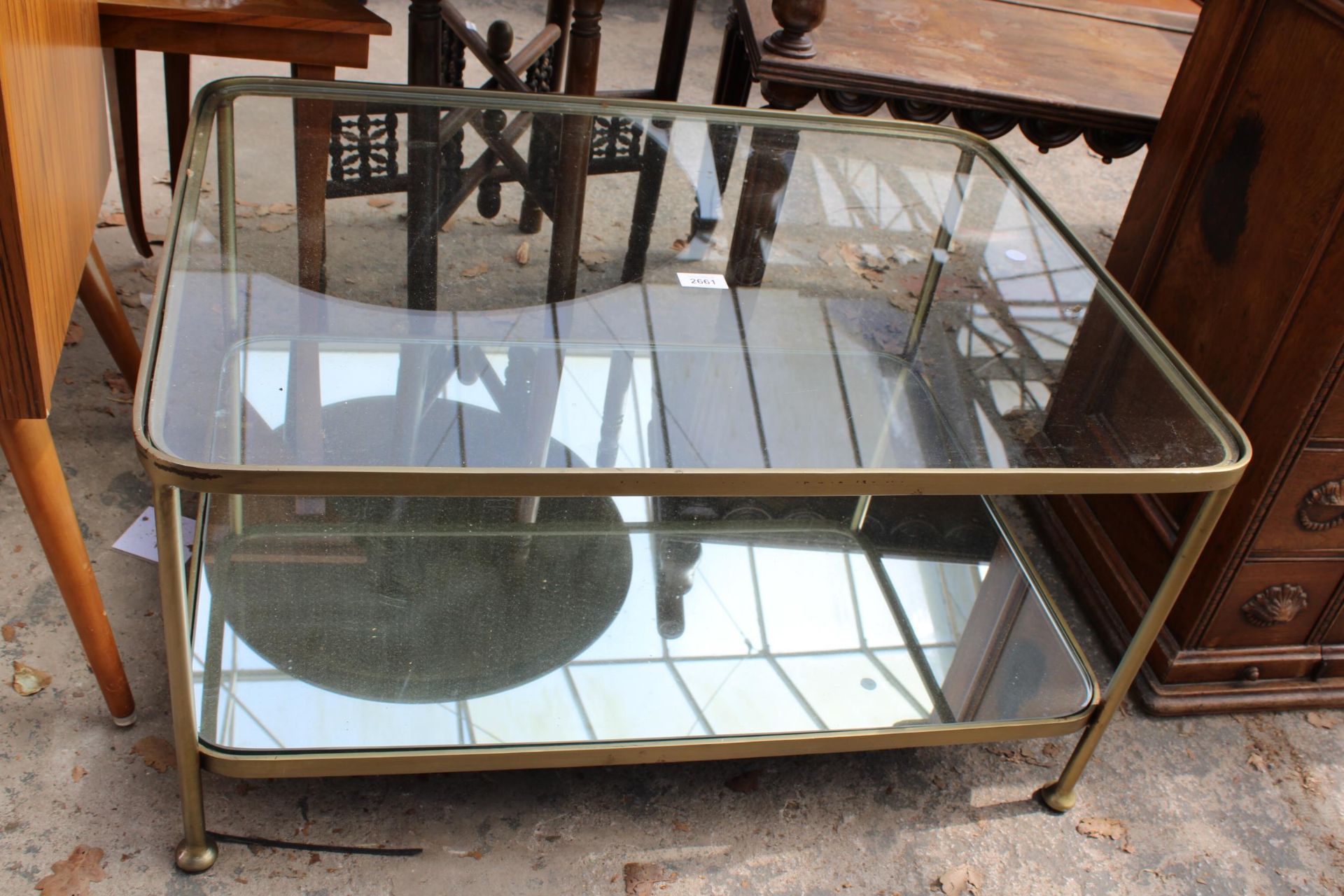 A MODERN METAL FRAMED COFFEE TABLE WITH MIRRORED BASE SHELF AND GLASS TOP SHELF, 31" X 23"