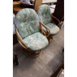 A PAIR OF BAMBOO AND WICKER SWIVEL EASY CHAIRS