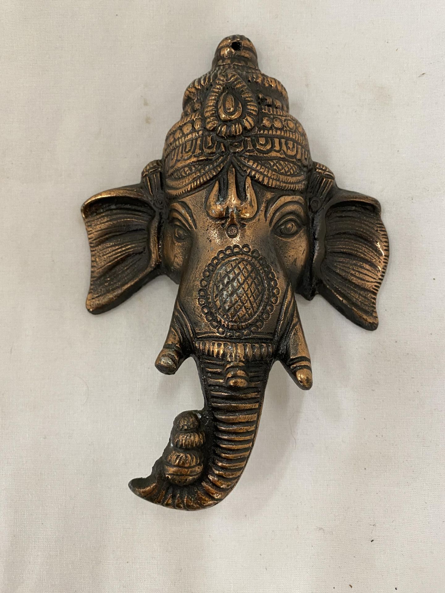 A BRONZE GANESHA SCULPTURE