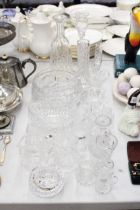 A LARGE QUANTITY OF GLASSWARE, THE MAJORITY CUT GLASS TO INCLUDE VASES, BOWLS, JUGS, CANDLE HOLDERS,