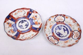 TWO ANTIQUE JAPANESE IMARI HAND PAINTED LOBED EDGED PLATES - 21 AND 22 CM