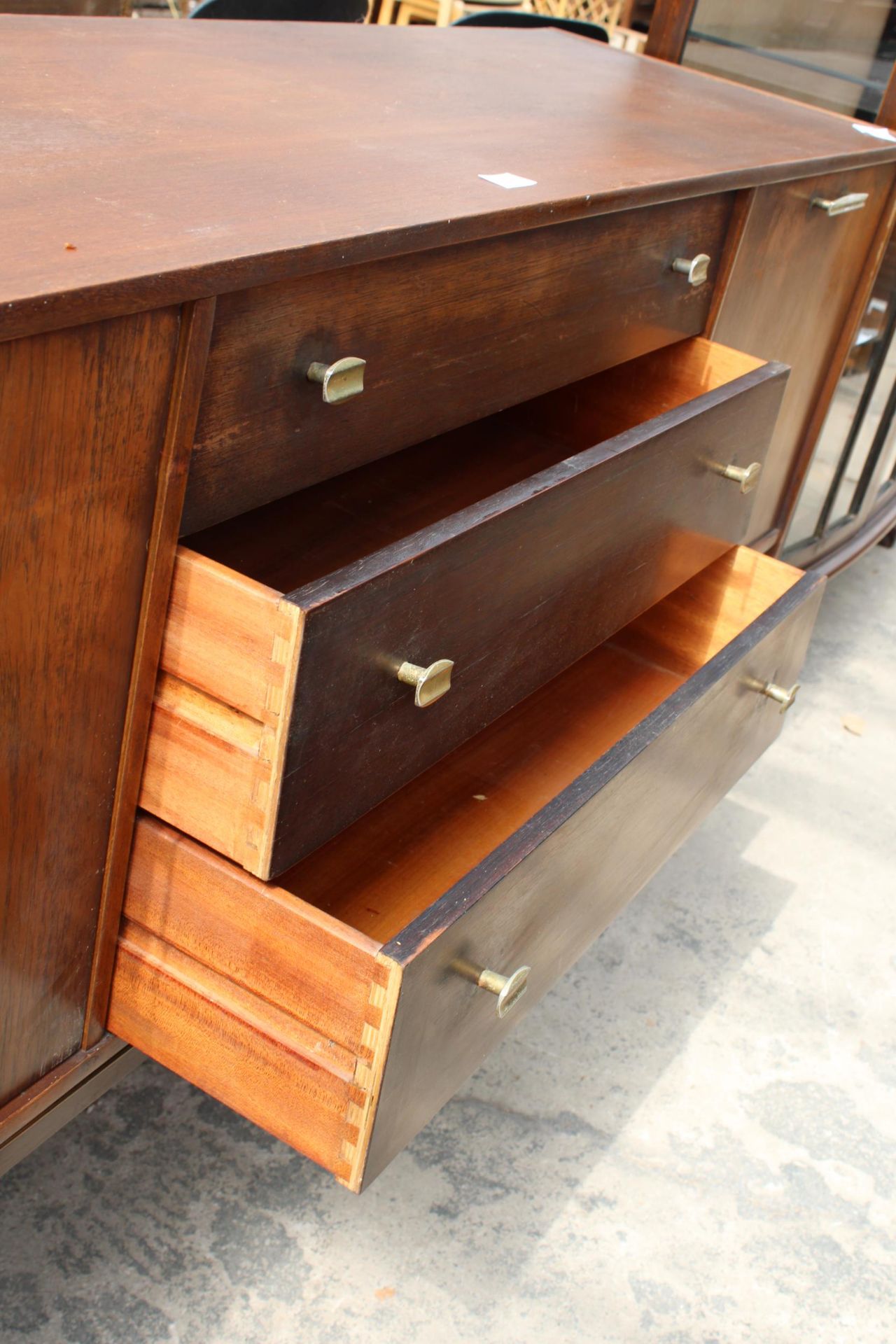 A RETRO TEAK SIDEBOARD ENCLOSING THREE DRAWERS AND TWO DROP-DOWN CUPBOARDS, 65" WIDE - Image 3 of 4