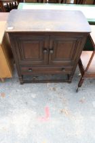 A JACOBEAN STYLE ELM TWO DOOR SIDE CABINET WITH SINGLE DRAWER, 31" WIDE