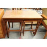 A RETRO TEAK McINTOSH NEST OF THREE TABLES WITH FOLD-OVER TOP