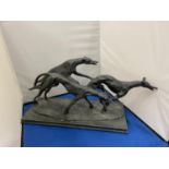 A LARGE RESIN SCULPTURE OF THREE GREYHOUNDS RUNNING ON A BASE LENGTH 38CM