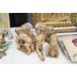 THREE LARGE CLAY MODELS OF GYMNASTS, PLUS FOUR WOODEN BABY BUDDAHS