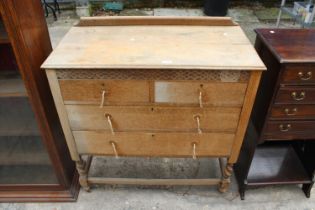 A MID 20TH CENTURY OAK CHEST OF TWO SHORT AND TWO LONG DRAWRS ON A BARLEY TWIST BASE 38" WIDE