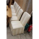 A SET OF EIGHT UPHOLSTERED SKIRT DINING CHAIRS