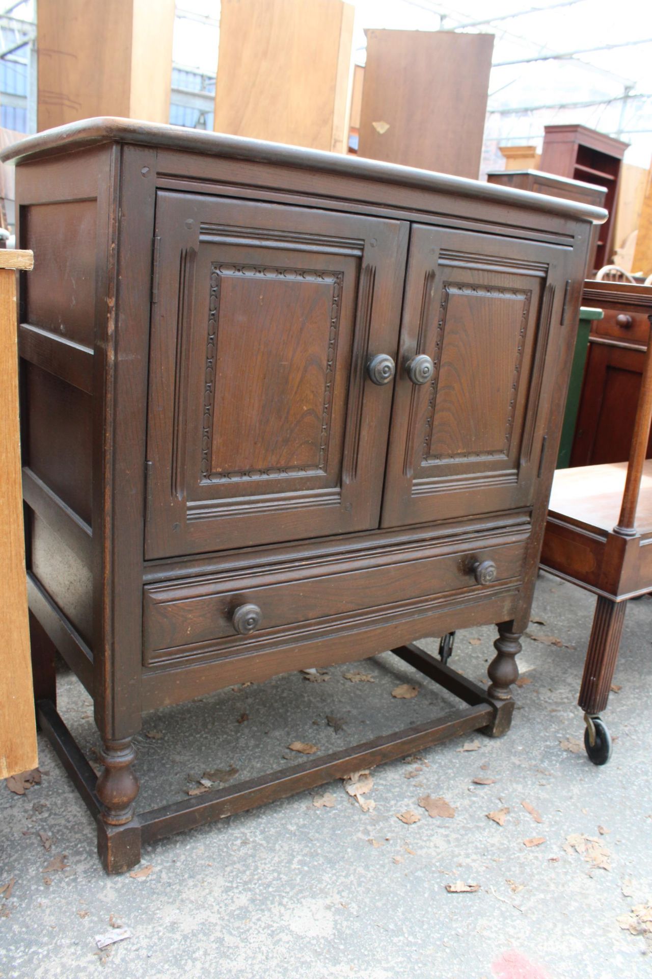 A JACOBEAN STYLE ELM TWO DOOR SIDE CABINET WITH SINGLE DRAWER, 31" WIDE - Image 2 of 2