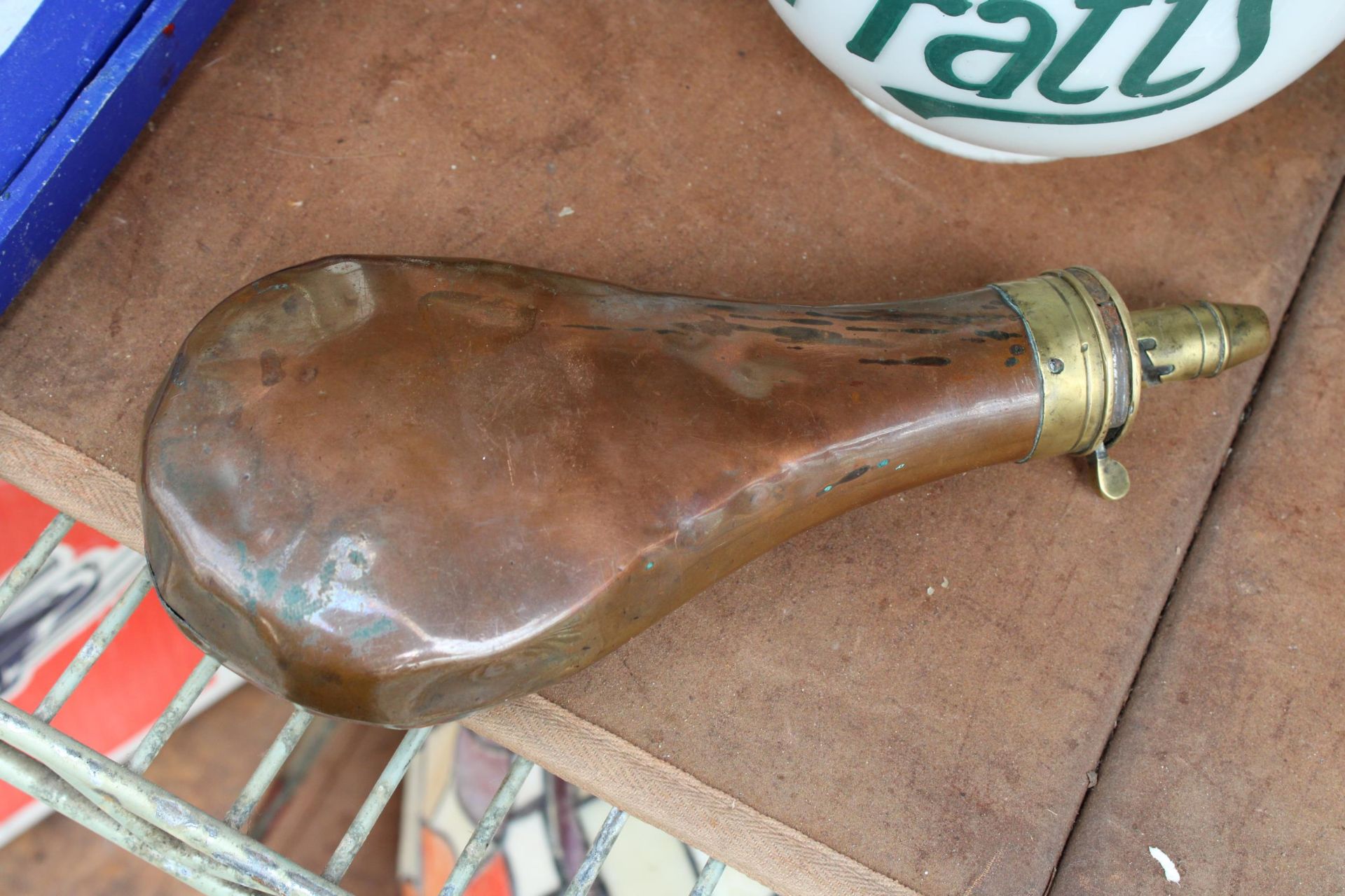 A VINTAGE COPPER MILITARY POWDER FLASK