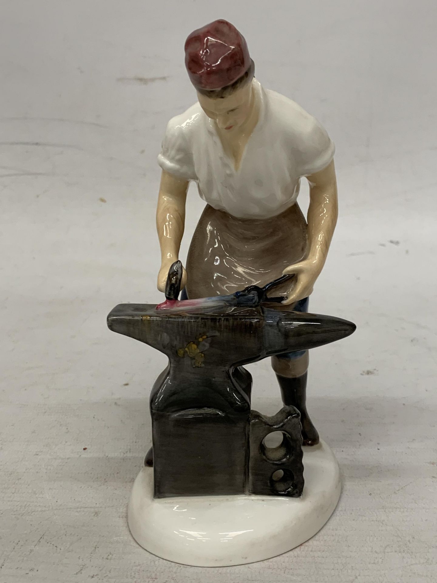 A ROYAL DOULTON FIGURE "THE BLACKSMITH OF WILLIAMSBURY" HN 2240