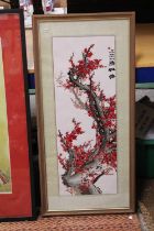 A JAPANESE EMBROIDERY OF CHERRY BLOSSOMS FRAMED AND GLAZED - 78 CM X 29 CM