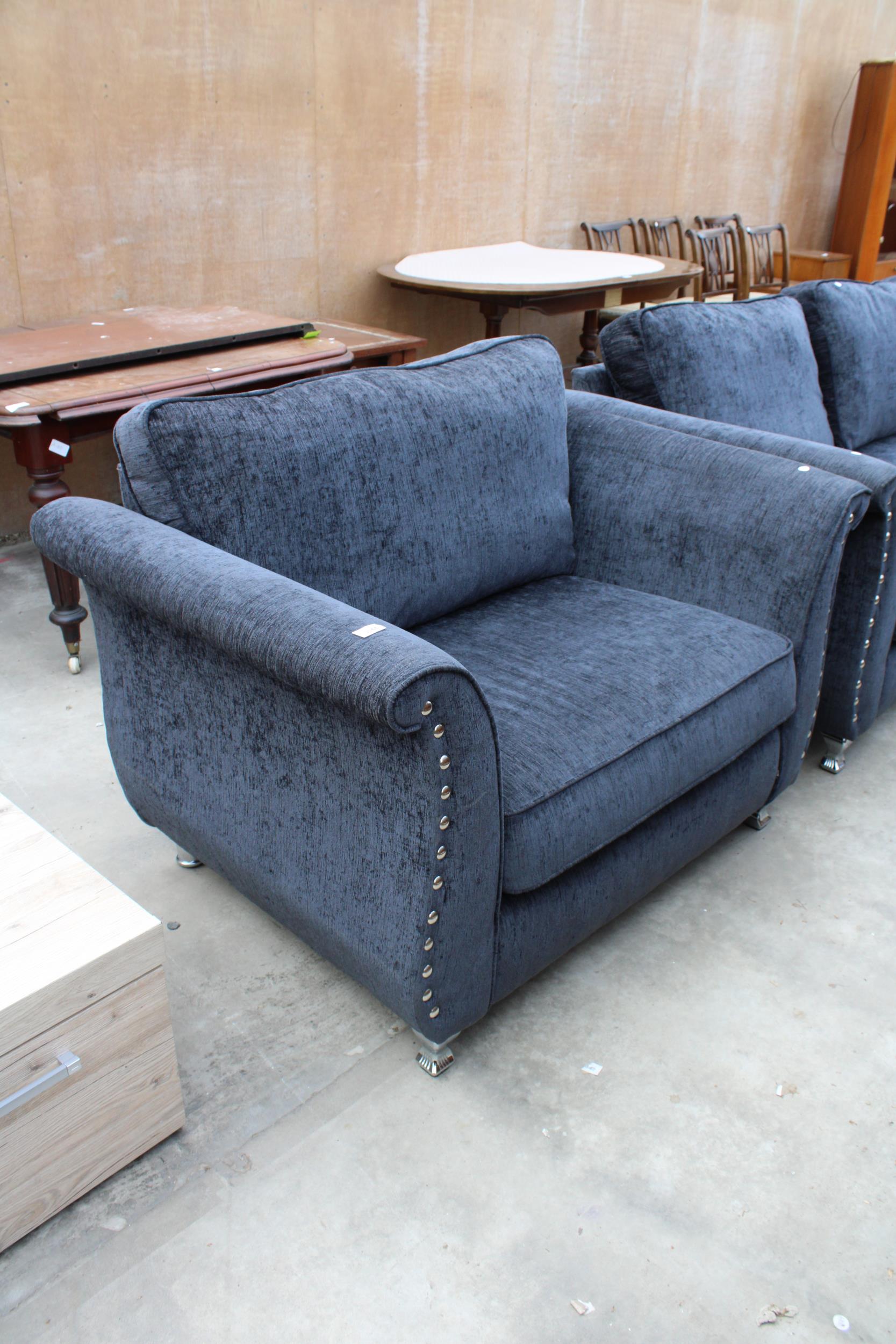 A MODERN SLATE GREY EASY CHAIR WITH POLISHED CHROME BUTTONED ARMS AND LEGS