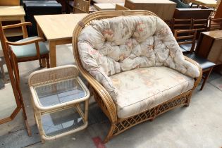 A MODERN BAMBOO SETTEE AND A SMALL GLASS TOP TABLE