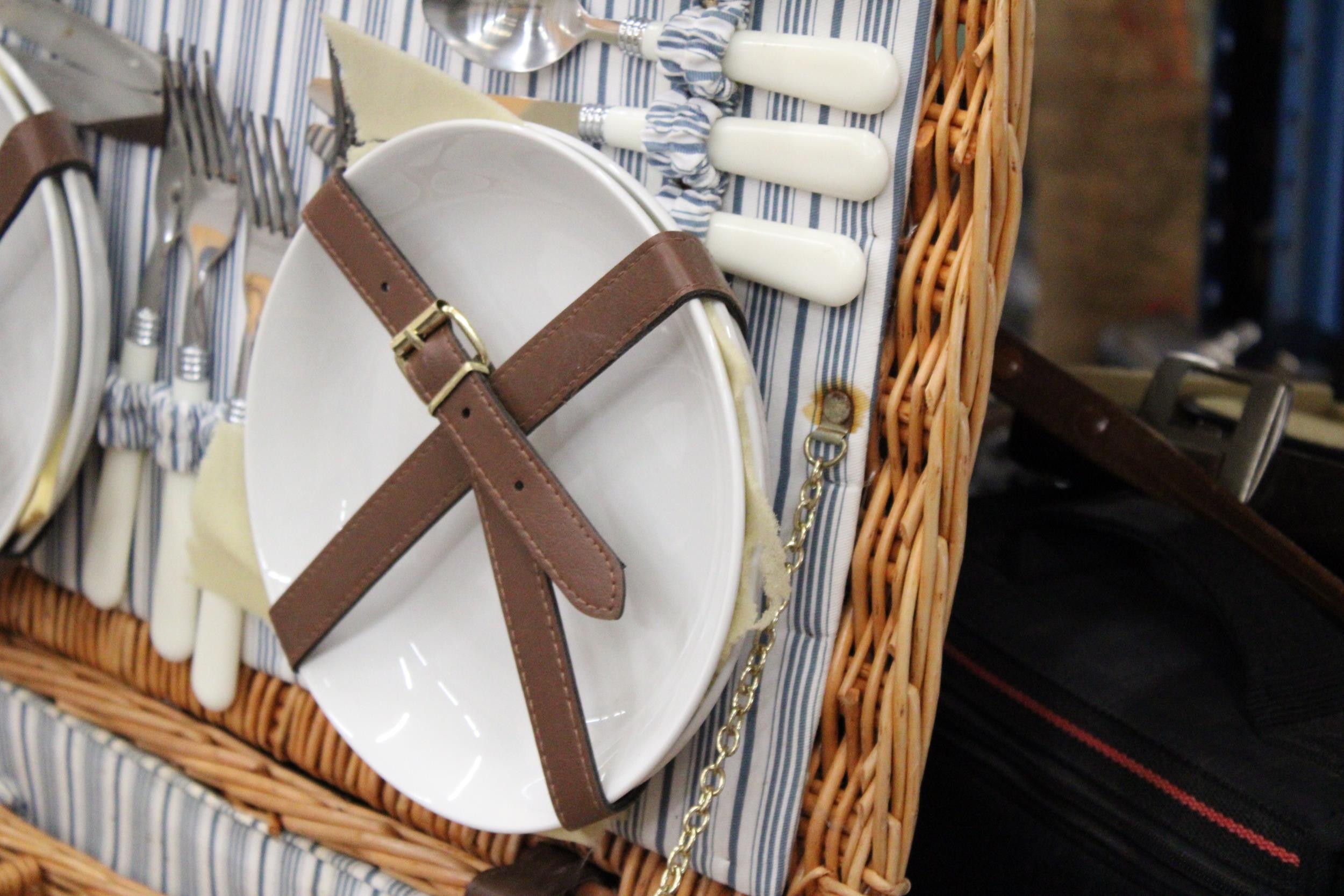 A LARGE WICKER PICNIC HAMPER CONTAINING CERAMIC CUPS AND PLATES, PLUS CUTLERY, A BOTTLE OPENER AND - Image 3 of 5