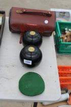 A PAIR OF CROWN GREEN BOWLING WOODS AND A CARRY BAG
