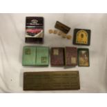 A BRASS CRIB BOARD AND THREE PACKS OF VINTAGE CARDS
