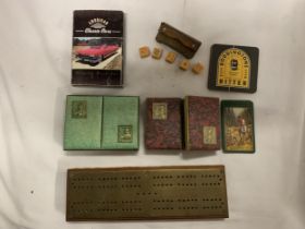 A BRASS CRIB BOARD AND THREE PACKS OF VINTAGE CARDS