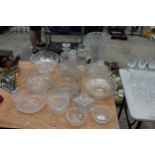 AN ASSORTMENT OF HEAVY CUT GLASS ITEMS TO INCLUDE VASES, BOWLS AND DECANTERS ETC