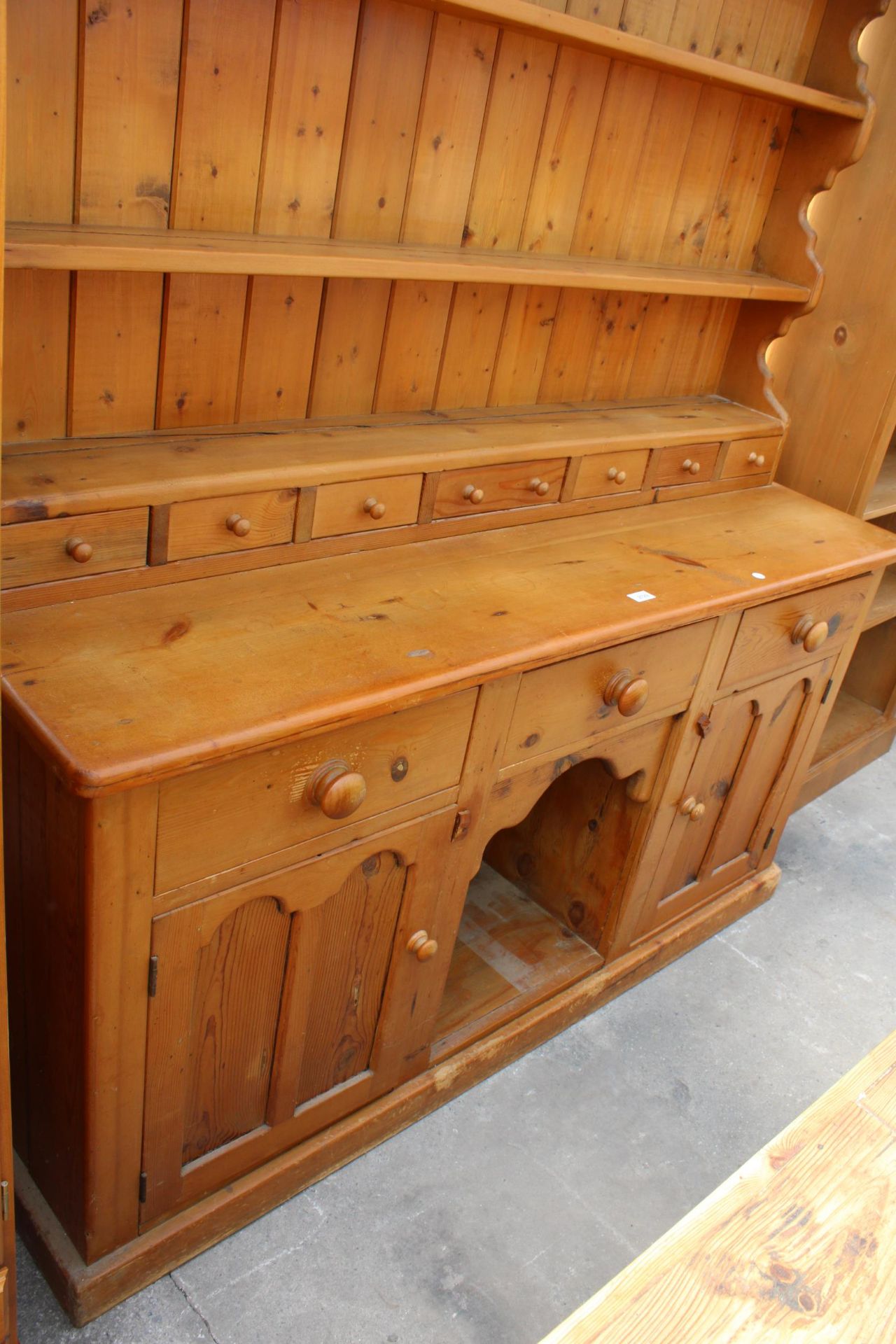A VICTORIAN STYLE PINE KITCHEN DRESSER WITH PLATE RACK ENCLOSING SEVEN SPICE DRAWERS, THE BASE - Image 2 of 3