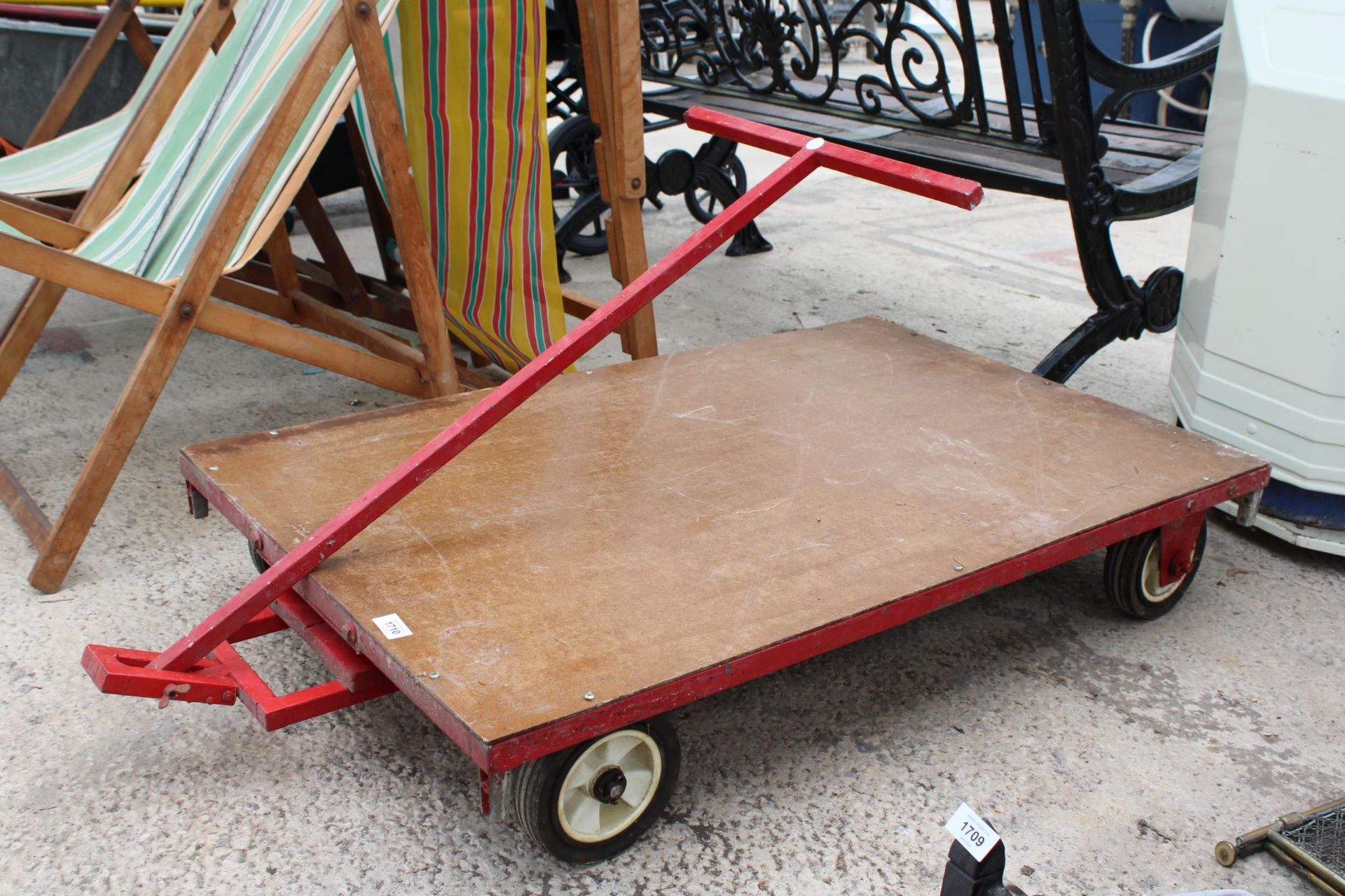 A LOW FOUR WHEELED PULL ALONG TROLLEY