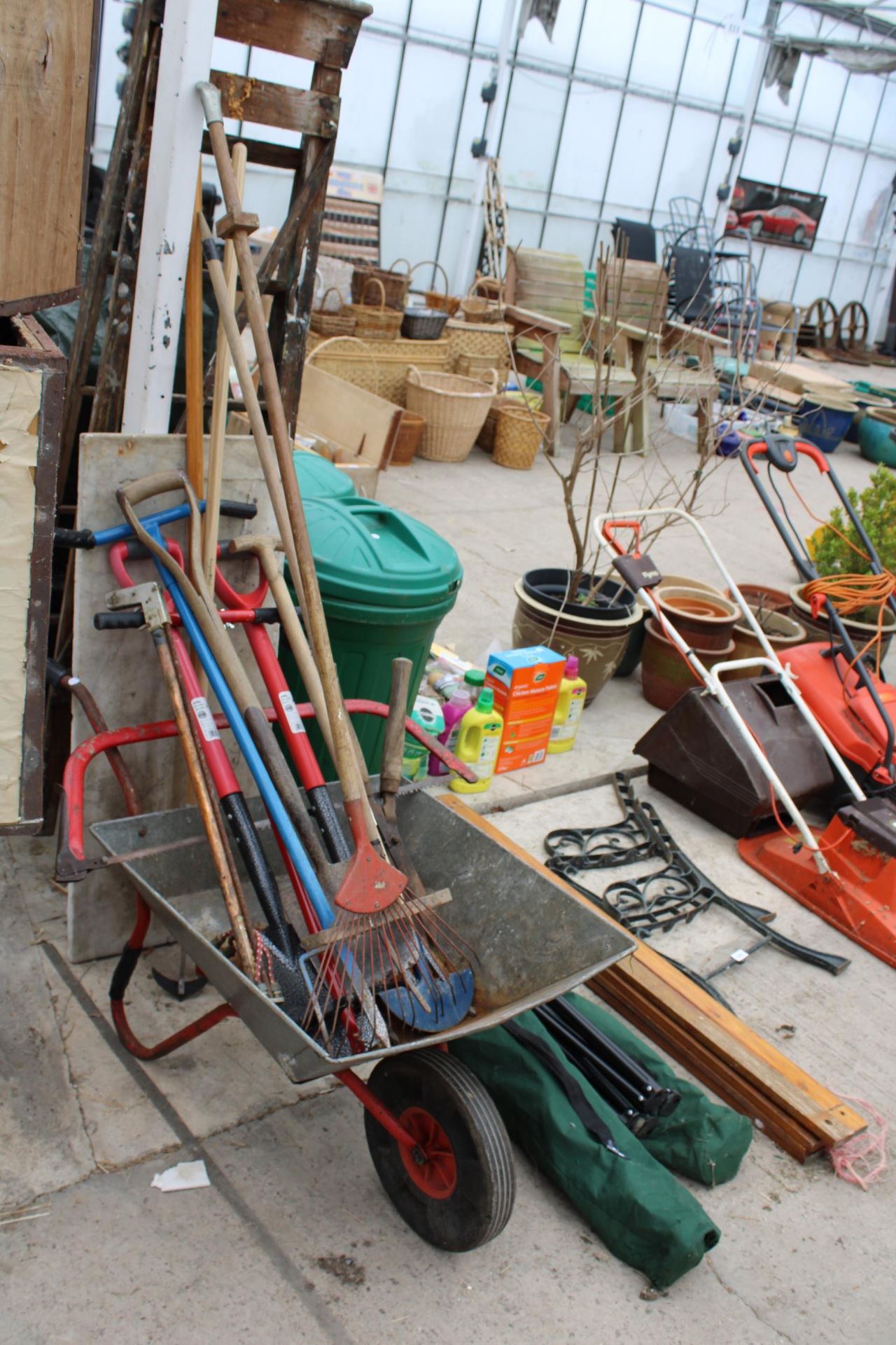 A METAL WHEEL BARROW, AN ASSORTMENT OF GARDEN TOOLS AND A PIECE OF MARBLE
