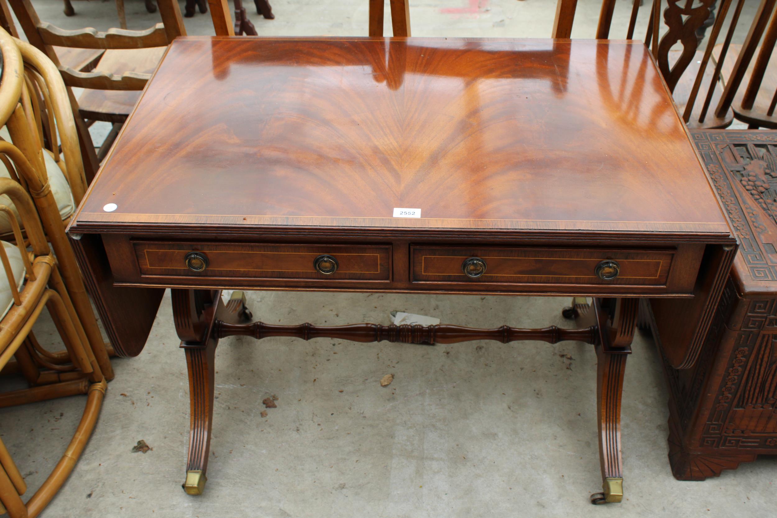 A 19TH CENTURY STYLE MAHOGANY AND CROSSBANDED LYRE END SOFA TABLE