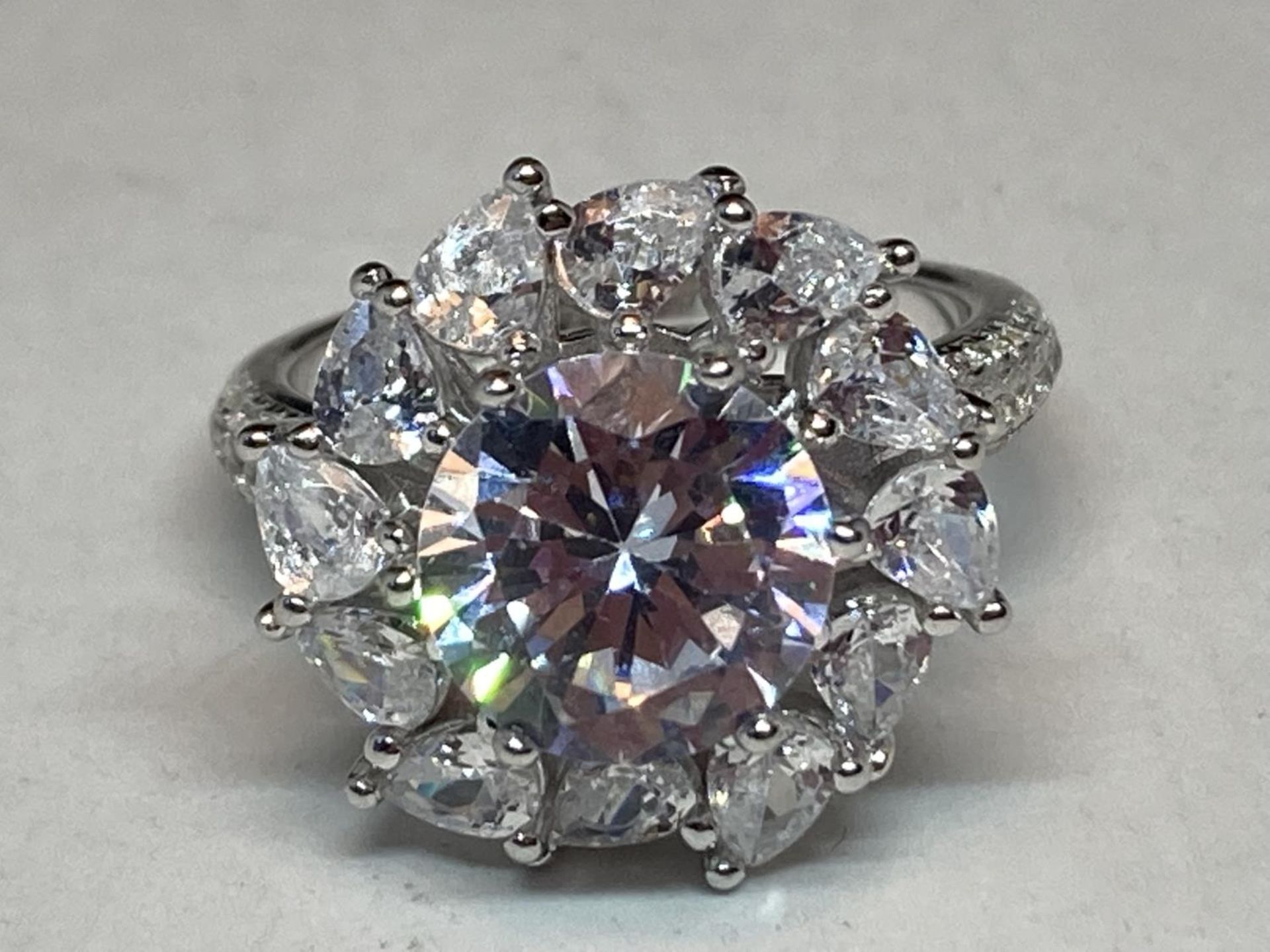 A WHITE METAL RING WITH 3 CARATS OF MOISSANITE STONES IN A FLOWER DESIGN AND ON THE SHOULDERS SIZE N - Image 2 of 8