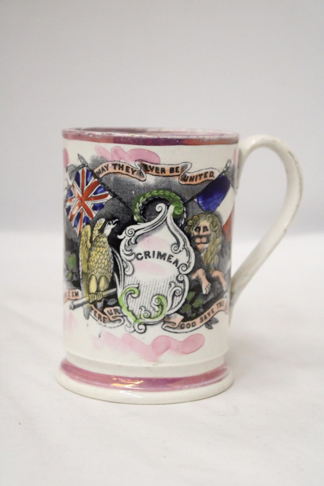 A 19TH CENTURY STAFFORDSHIRE POTTERY FROG MUG WITH 'GOD SAVE THE QUEEN' EMBLEM