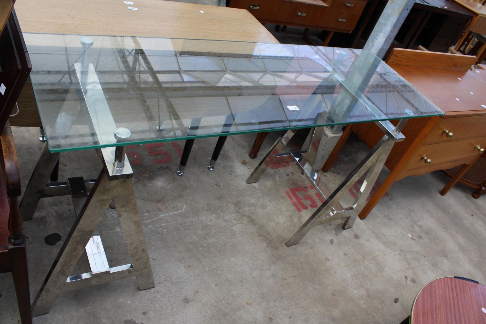 A RETRO CONSOLE TABLE WITH GLASS TOP ON POLISHED CHROME TRESTLE STYLE LEGS, 59" X 20"