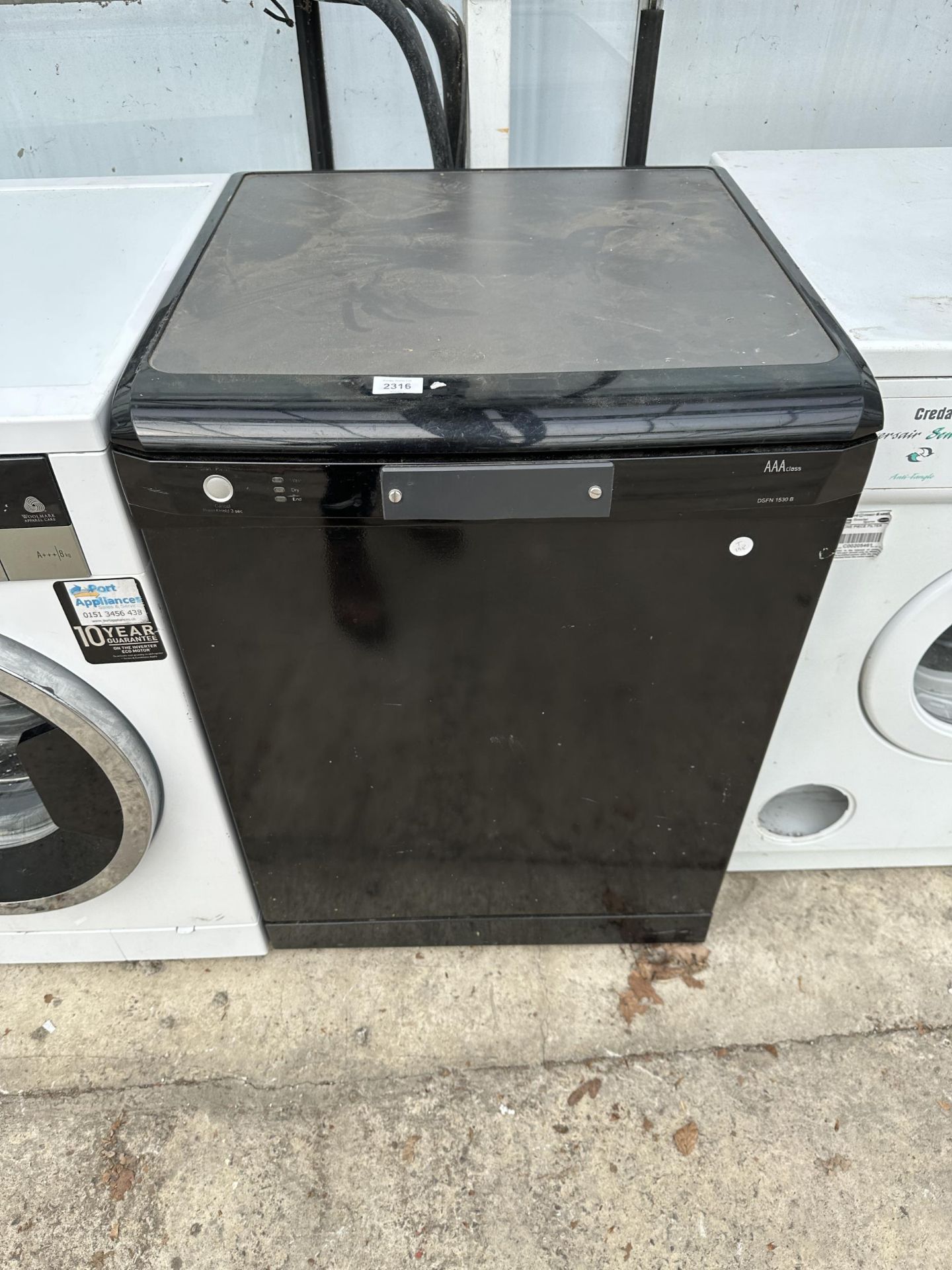 A BLACK UNDERCOUNTER DISH WASHER