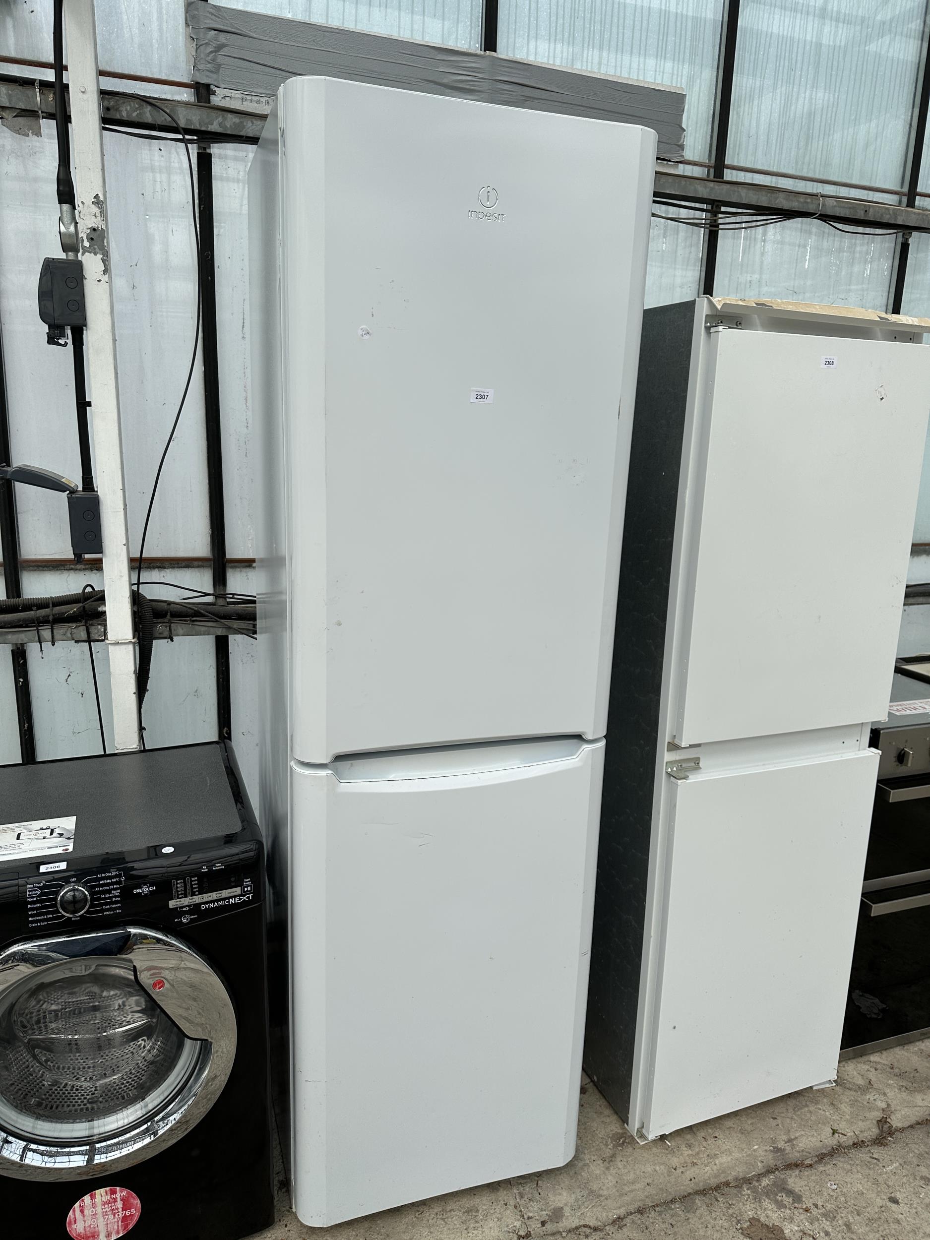 A TALL WHITE INDESIT UPRIGHT FRIDGE FREEZER