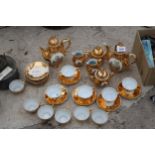 AN ASSORTMENT OF GILT CERAMIC TEA SERVICE ITEMS TO INCLUDE CUPS AND SAUCERS AND TEAPOTS ETC