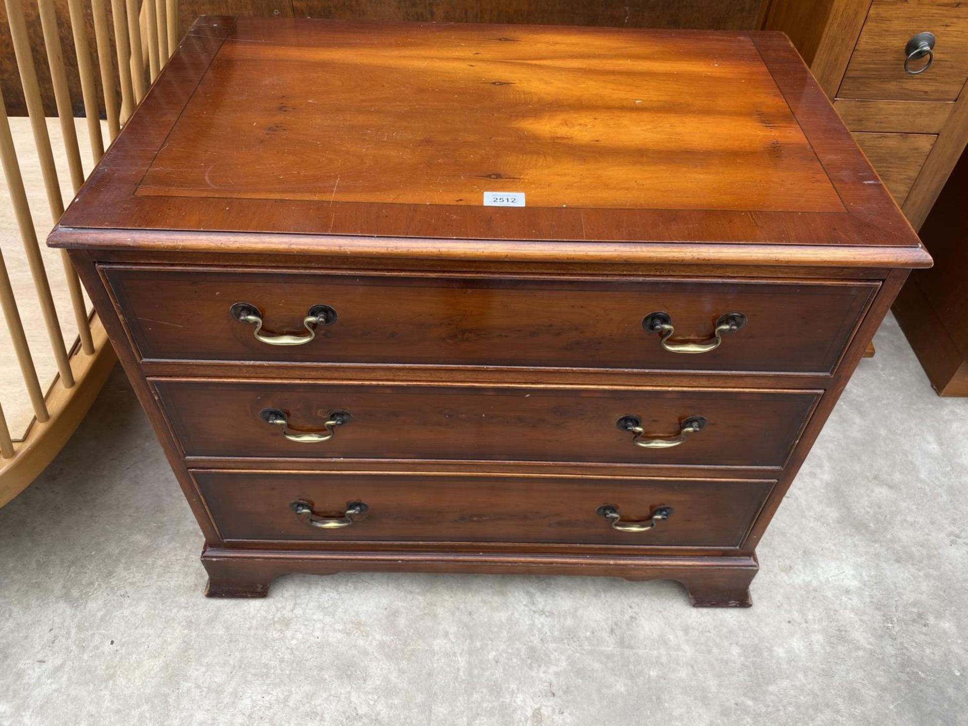 A YEW WOOD AND CROSSBANDED CHEST OF THREE DRAWERS, 30" WIDE