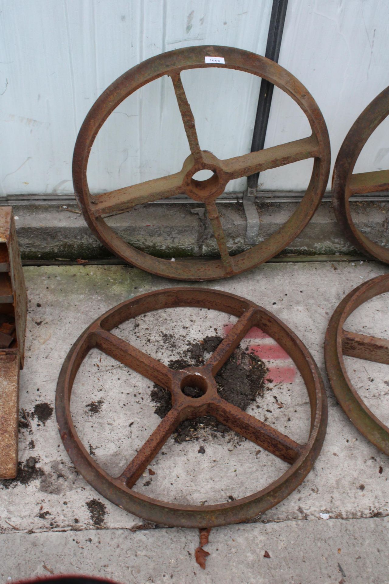 A PAIR OF VINTAGE CAST IRON TRAIN WHEELS