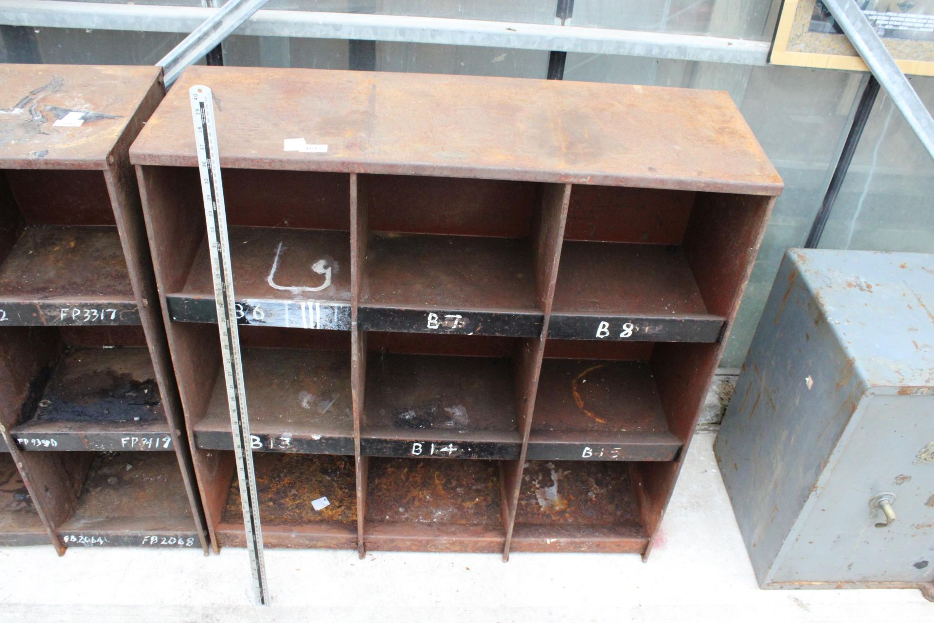 A NINE SECTION METAL PIGEON HOLE UNIT