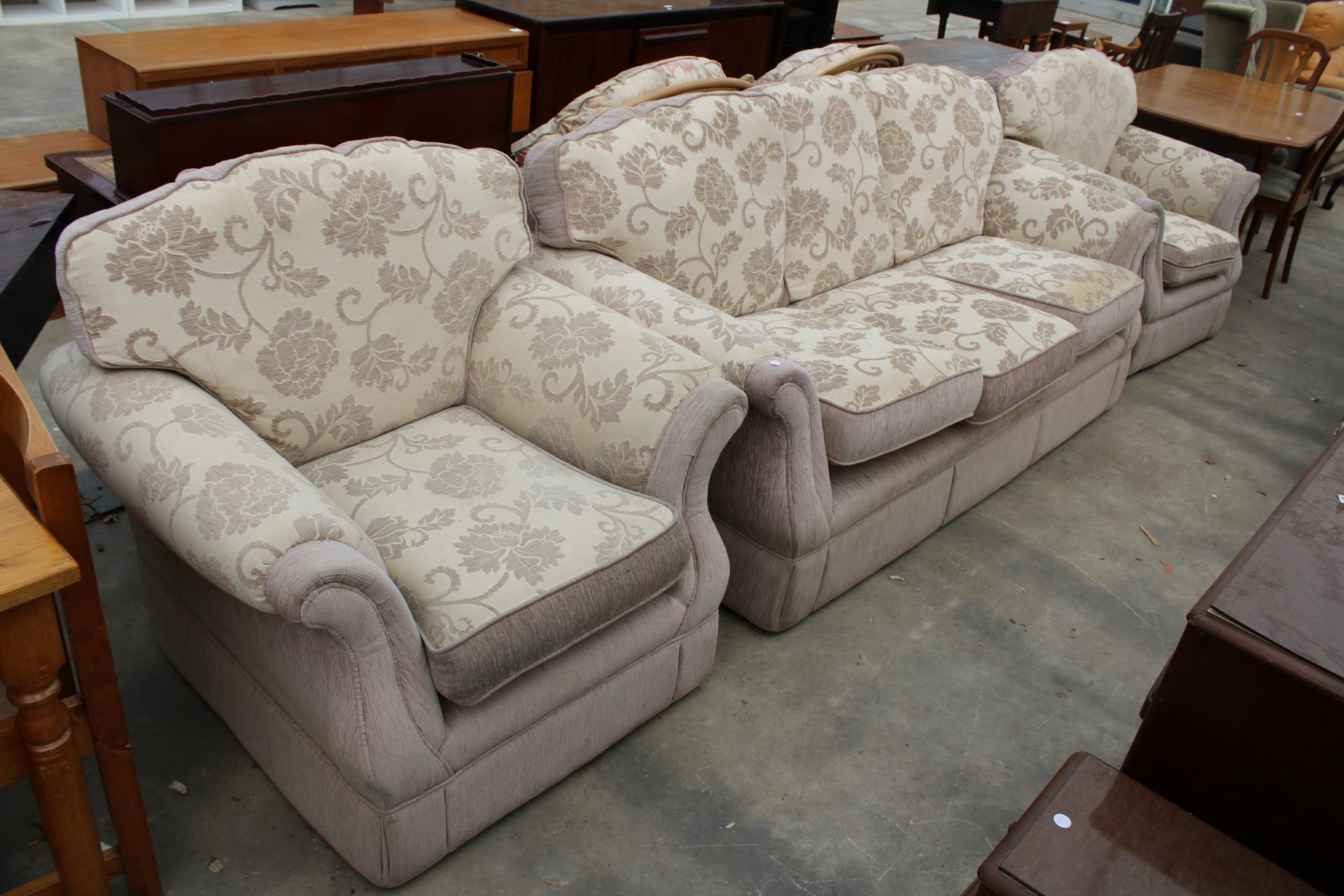 A MODERN FLORAL THREE PIECE SUITE WITH SIX LOOSE CUSHIONS