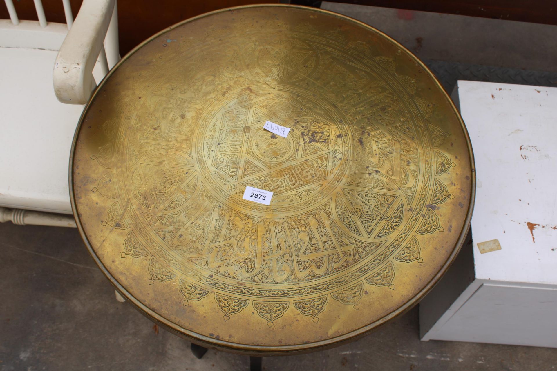 A BRASS 23" DIAMETER INDIAN COFFEE TABLE ON EBONISED FOLDING BASE - Image 2 of 2