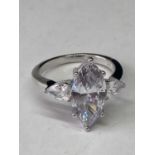 A WHITE METAL RING WITH 5 CARATS OF MOISSANITES SIZE O/P