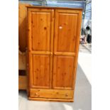 A MODERN PINE TWO DOOR WARDROBE WITH DRAWER TO BASE 37" WIDE