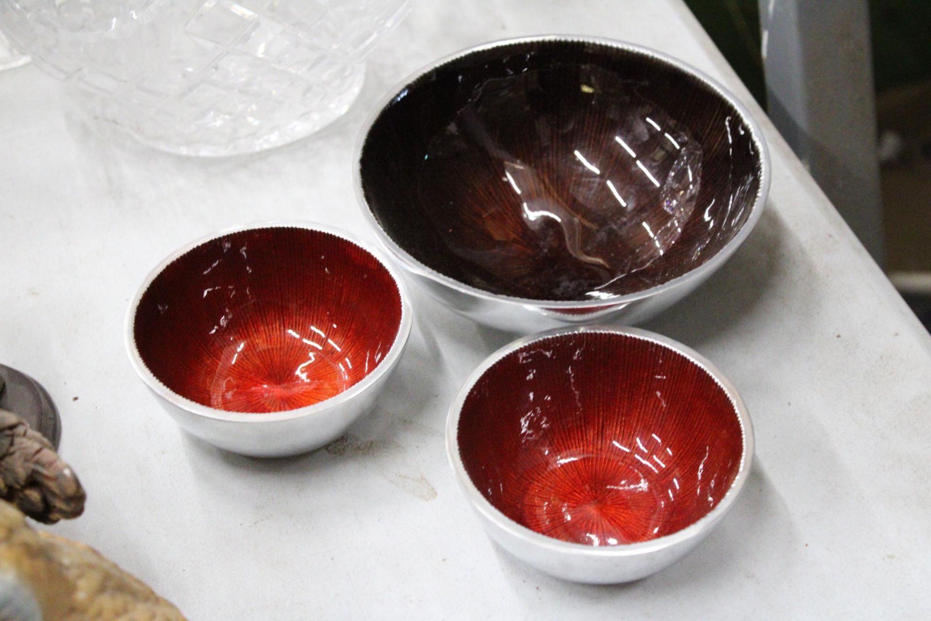 THREE MATCHING DESIGNER ENAMELLED BOWLS