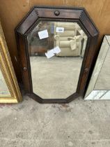 AN OAK FRAMED OCTAGONAL MIRROR