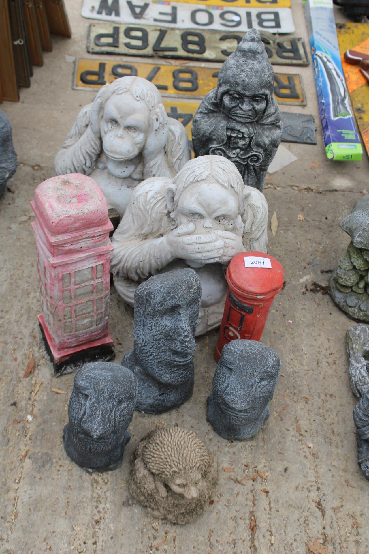 TEN CONCRETE GARDEN FIGURES TO INCLUDE A PHONE BOX, MONKIES AND A POST BOX ETC